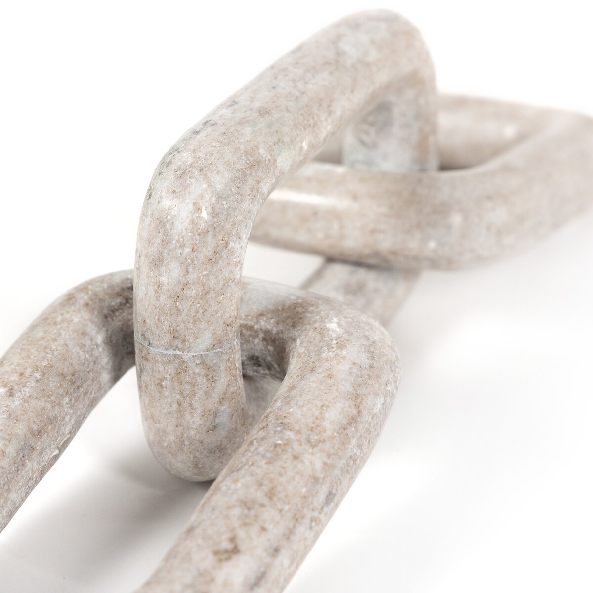 Close-up of interlocking creamy taupe marble links